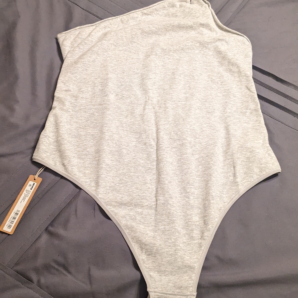 Skims one shoulder body suit